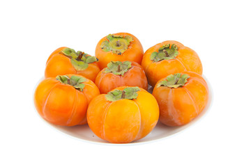 tasty ripe persimmon isolated on plate on  white
