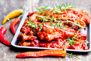 Raw  marinated pork ribs on metal tray. Ready for BBQ