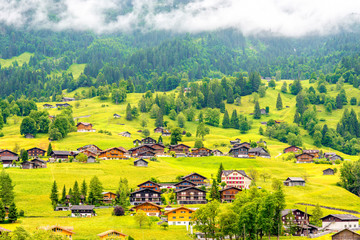 Beautiful rural landscape view on the green mountains and village near Interlaken city in...