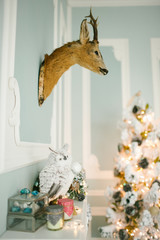 Christmas decorated room with deer head on the wall