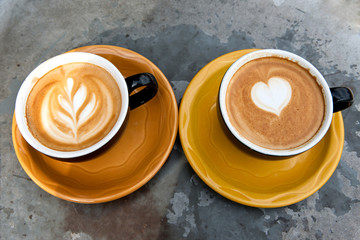 Art milk mocha coffee with foam on metal table