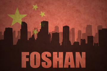 Fototapeta premium abstract silhouette of the city with text Foshan at the vintage chinese flag background