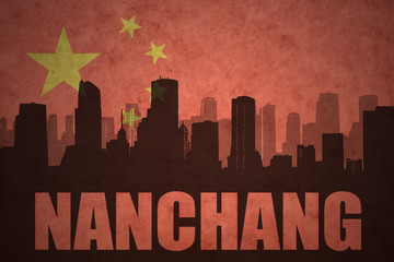 Fototapeta premium abstract silhouette of the city with text Nanchang at the vintage chinese flag background