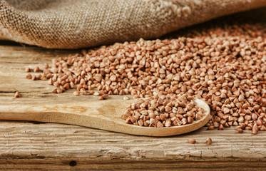 buckwheat groats and wooden spoon