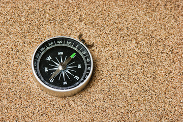 Fototapeta na wymiar compass on a sandy beach