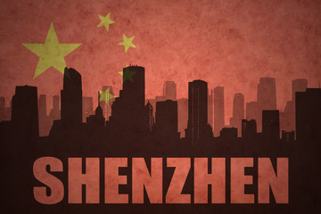 abstract silhouette of the city with text Shenzhen at the vintage chinese flag background