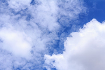 Blue sky background with white clouds. The vast blue sky and clouds sky on sunny day. White fluffy clouds in the blue sky.