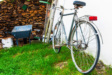 Fototapeta na wymiar Old vintage bike near pile of wood.