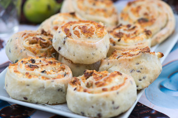 Freshly baked cheese bun rolls with herbs on a plate