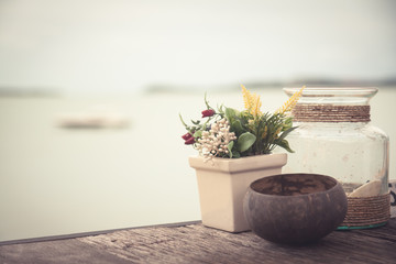 Beach view from cafe in vintage style with decoration accessories in rustic Provence style on old wooden table and horizon over sea 