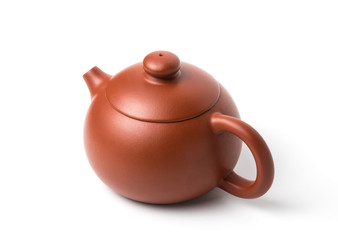 Small brown earthenware teapot with closed lid isolated on white