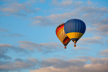 Colorful hot air balloon is flying at suset