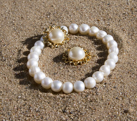 pearl bracelet and earrings lying