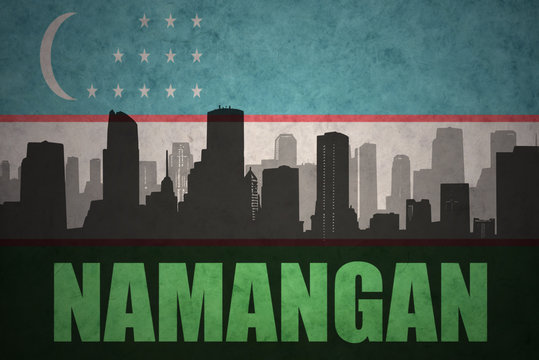 abstract silhouette of the city with text Namangan at the vintage uzbekistan flag background