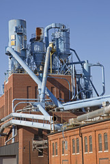 Dubuque, Iowa, October 2016: Storage tanks and piping are mounted on the roof of a manufacturing plant in the historic Millwork District in Dubuque, Iowa. © geraldmarella