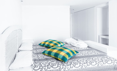 White themed bed sheets and  curtain in morning, bedroom interior.