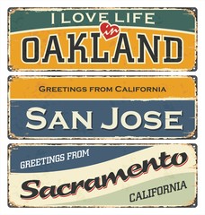 Vintage tin sign collection with USA cities. Oakland. San Jose. Sacramento. Retro souvenirs or postcard templates on rust background.