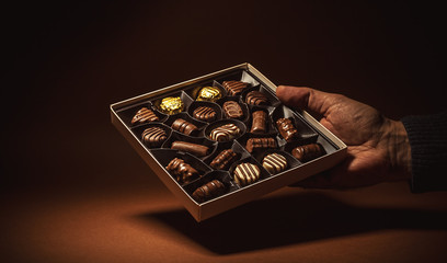 Box Chocolates in a Hand - 123497864