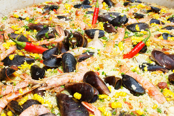 cooked mussels rice on street food festival.