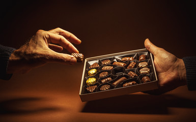 Box Chocolates in Hands - 123498061