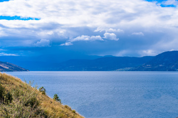 Fototapeta na wymiar Fantastic sky and clouds at Mountain Trail Park. Okanagan Lake. Canada.