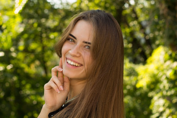 Young woman smiling on the background of trees