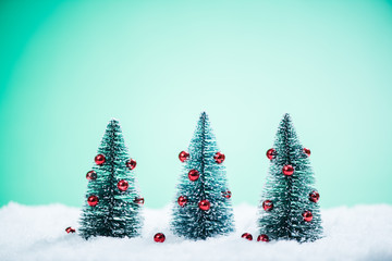 Christmas trees with decoration in snow