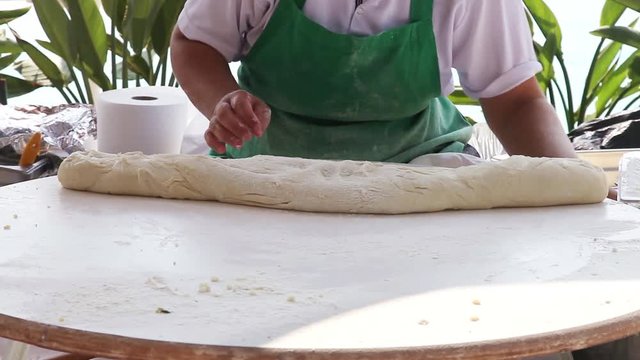 Turkish Woman Kneading Dough for preparing traditional pancakes gozleme
