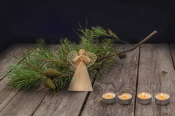 Advent background with pine branches  and straw angel
