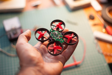 micro drone in hand  - obrazy, fototapety, plakaty