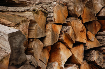 Pile of chopped logs for firewood texture background in autumn, ready for winter