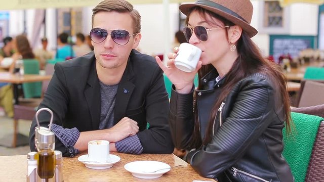 Restaurant tourists couple eating at outdoor cafe. Young woman and man enjoy time outside ay warm summer day