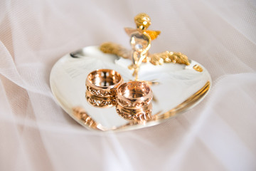 wedding rings lie on a platter
