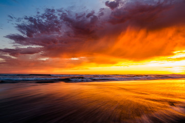Fototapeta na wymiar Sunset sky with ocean waves on the beach in La Jolla, California
