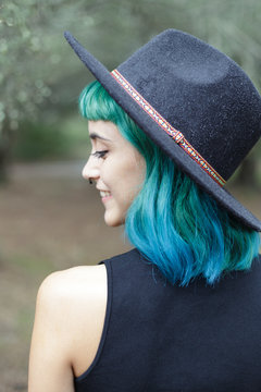 Close up of blue haired beauty looking back.