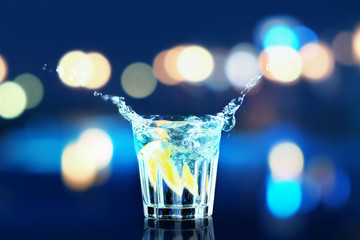 Colorful cocktail with splash on lights background