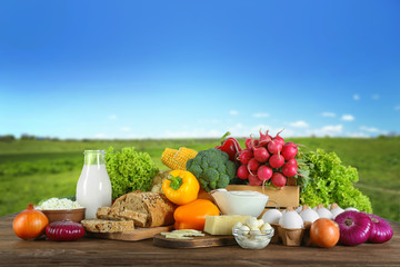 Vegetables and dairy products on blue sky background