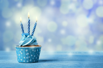 Delicious cupcake on table on light background