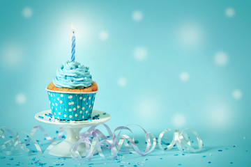 Delicious cupcake on table on blue background