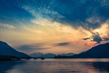 Beautiful sunset over the boats on lake in Scotland