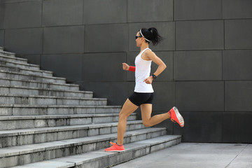 Fototapeta premium young sport woman running upstairs on city stairs