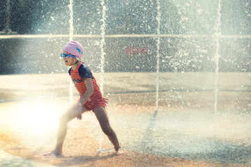 Kid sport extreme girl playing in fountain