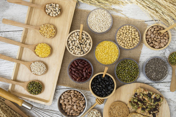 Group of beans and grains on wood table background