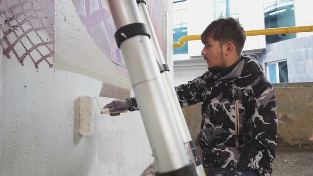 graffiti artist painting on the wall, slow motion