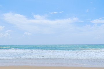 Empty sandy beach with sea under blue sky in thailand
