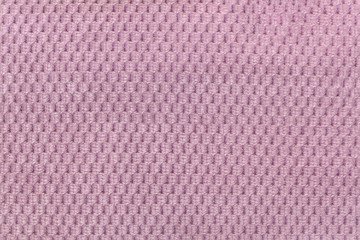Pink background from soft fleecy fabric closeup. Texture of textile macro.