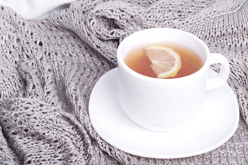 Having a cup of tea on gray blanket in bed.toned foto