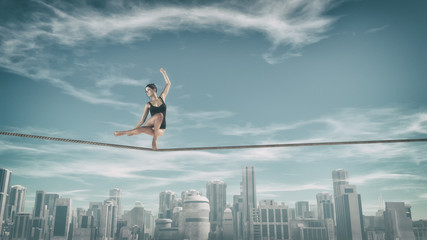Gymnast tightrope above city