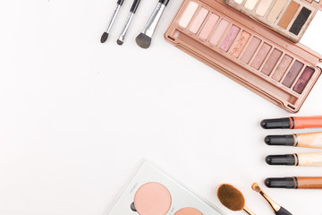 makeup products on white background with copyspace