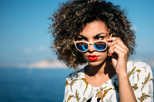 Mixed race girl strictly looking over sunglasses
